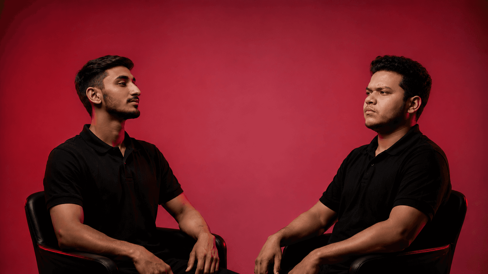 Kaarim Hussain and Asim Sarfaraz, founders of Klyron Studio, seated against a crimson background